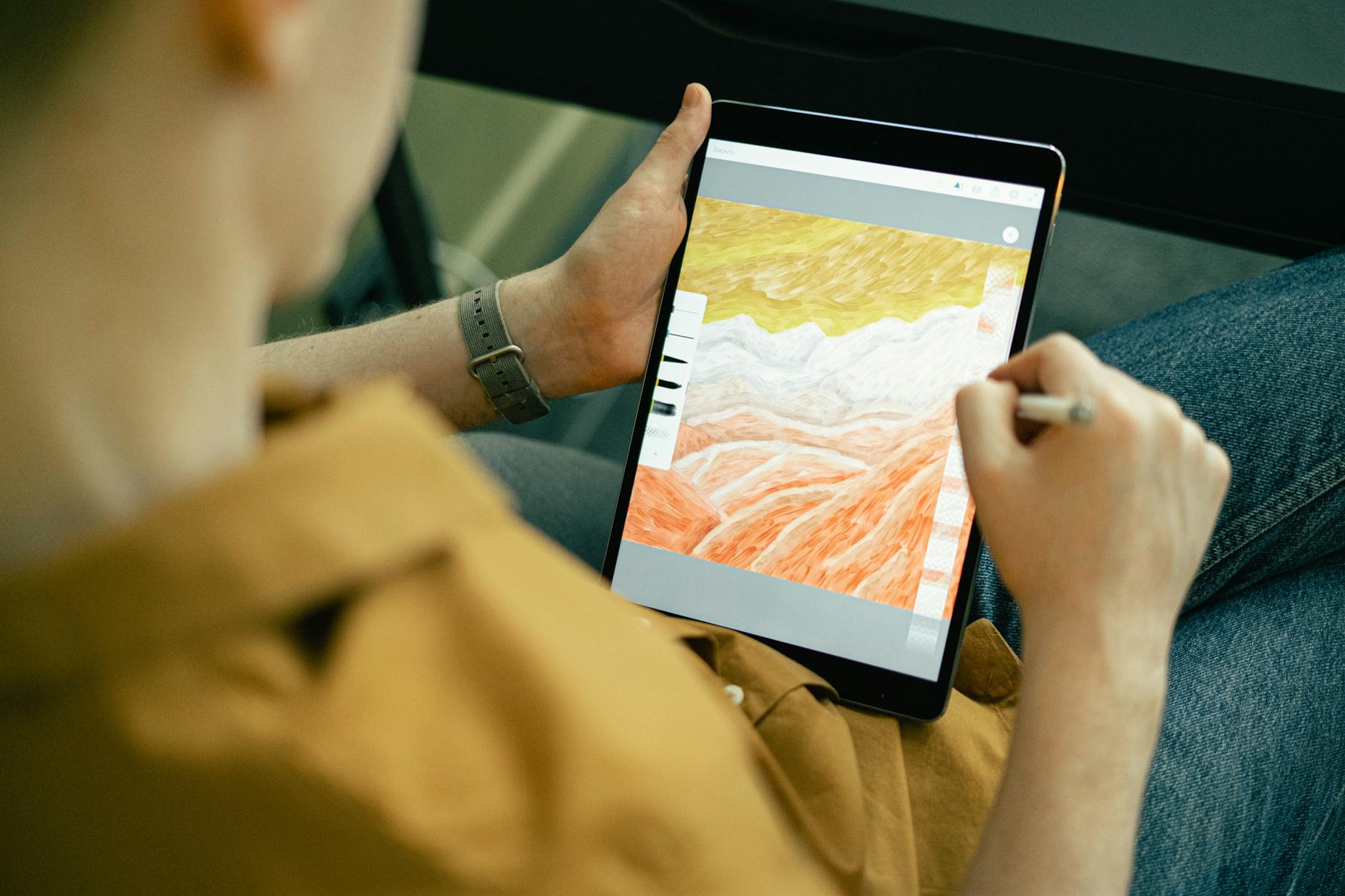 person drawing on a tablet